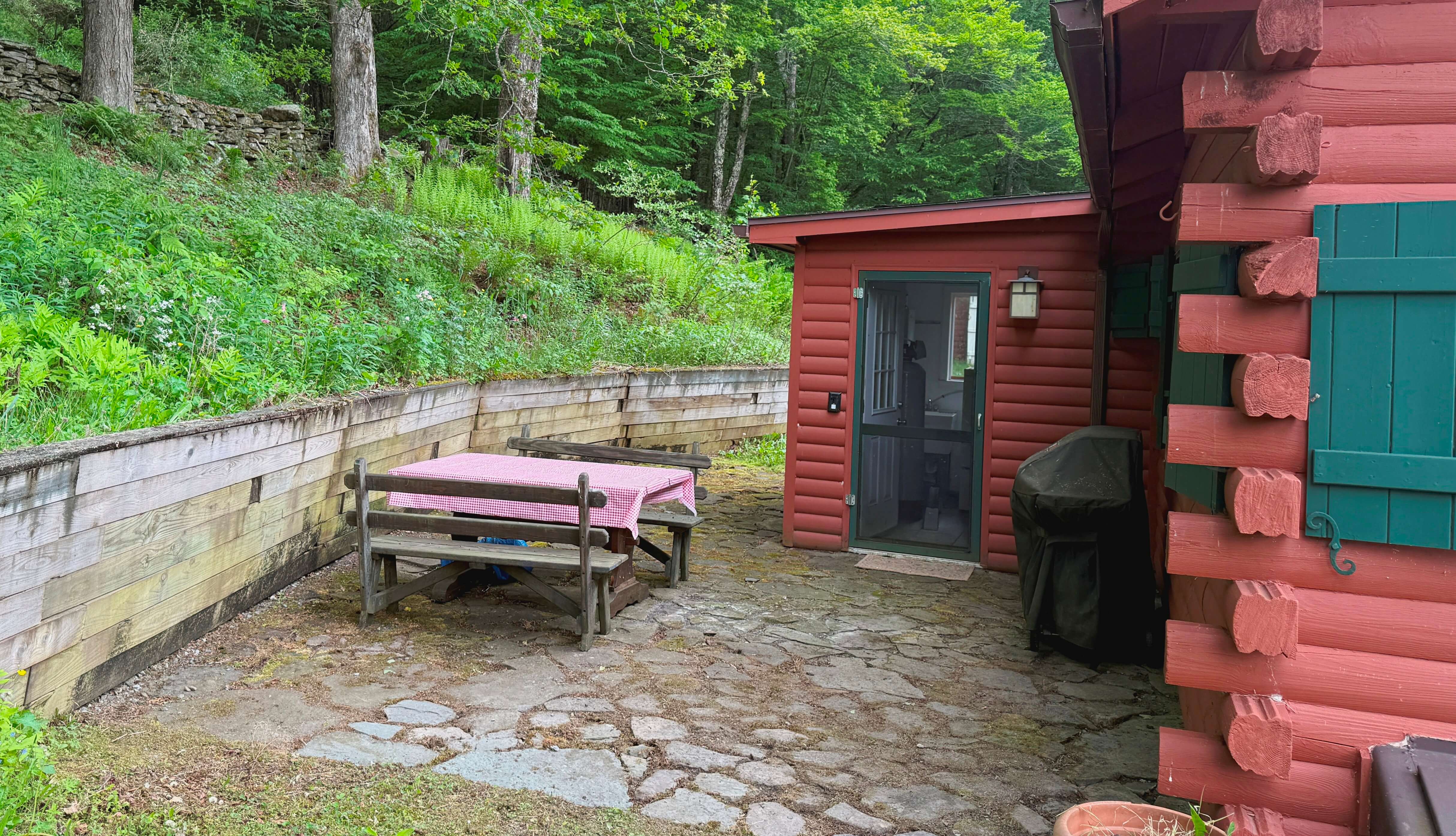 Back patio off of the mud room. Picnic table and gas grill.